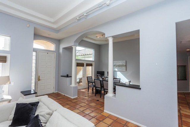 entryway with rail lighting and tile patterned flooring