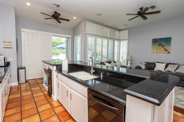 kitchen with dishwasher, sink, white cabinetry, a center island with sink, and ceiling fan