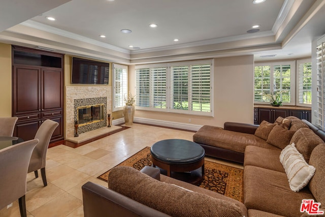 living room with a raised ceiling, light tile patterned flooring, and crown molding