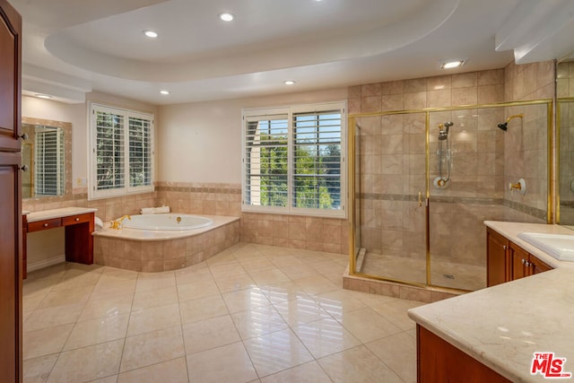 bathroom featuring tile patterned flooring, a raised ceiling, vanity, and separate shower and tub