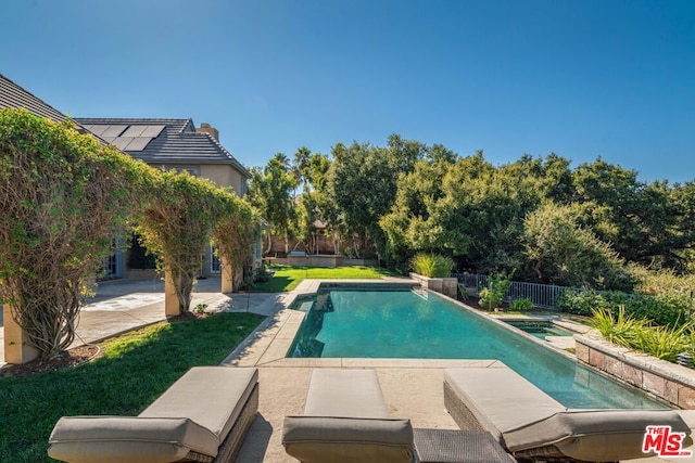 view of pool with a patio area and a yard