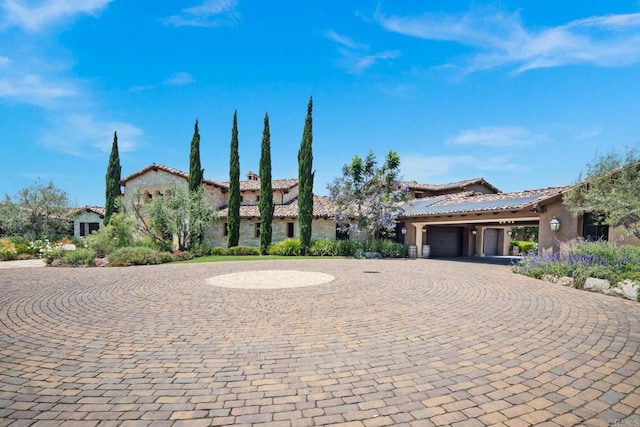 mediterranean / spanish-style house with a garage