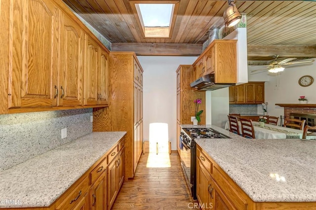 kitchen featuring high end range, light wood-type flooring, wood ceiling, ceiling fan, and beam ceiling