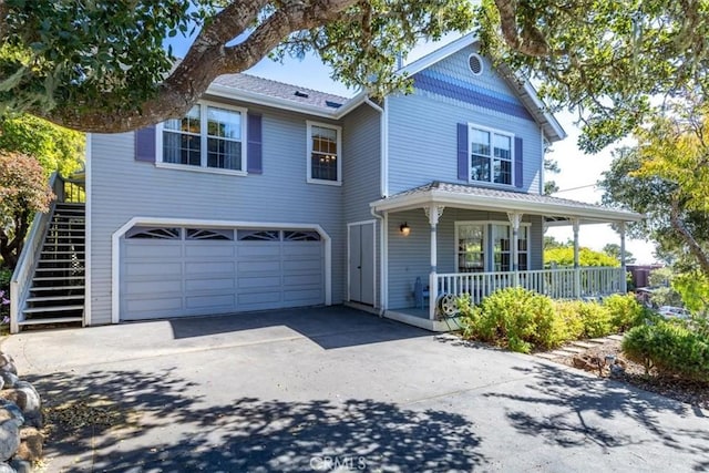 view of front of house with a porch and a garage