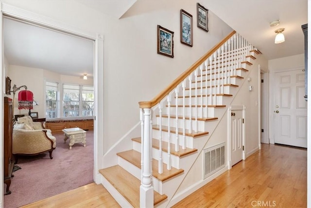 staircase featuring wood-type flooring