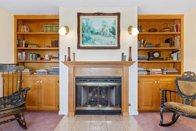 living area with built in shelves and light tile patterned floors