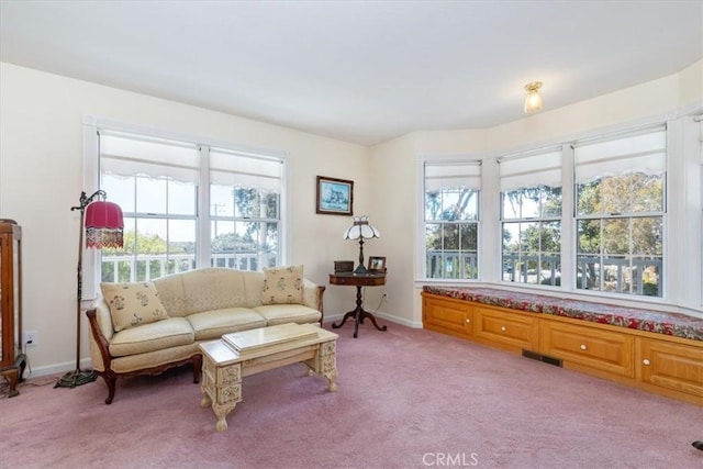 sitting room featuring light colored carpet