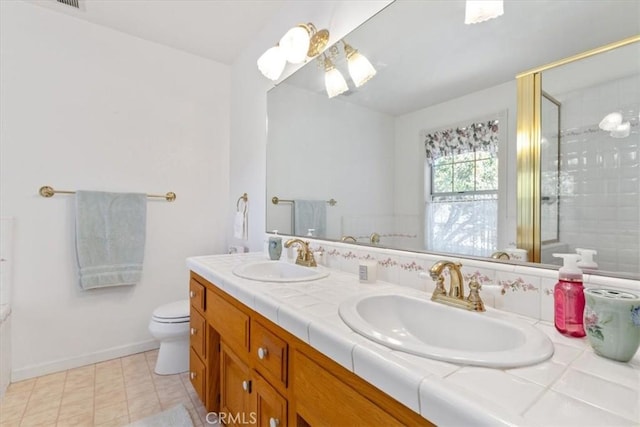 bathroom featuring toilet, walk in shower, tile patterned floors, and vanity