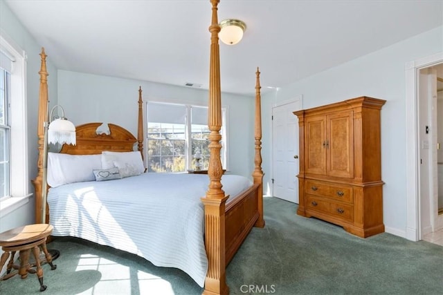 bedroom with dark colored carpet