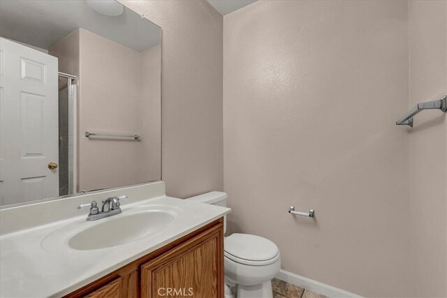 bathroom featuring tile patterned floors, toilet, and vanity