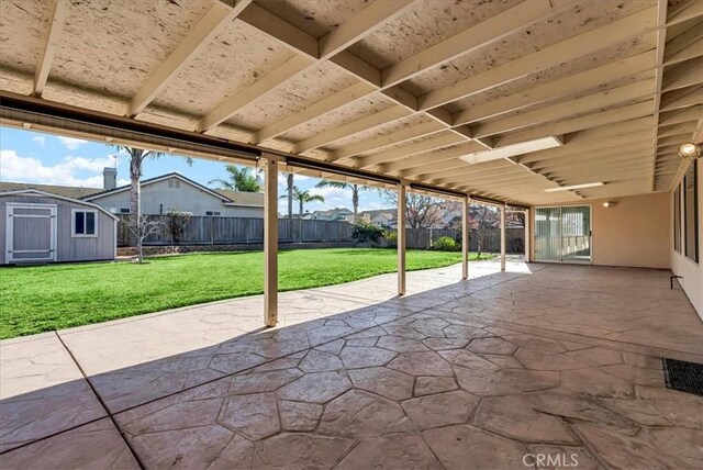 view of patio with a storage shed