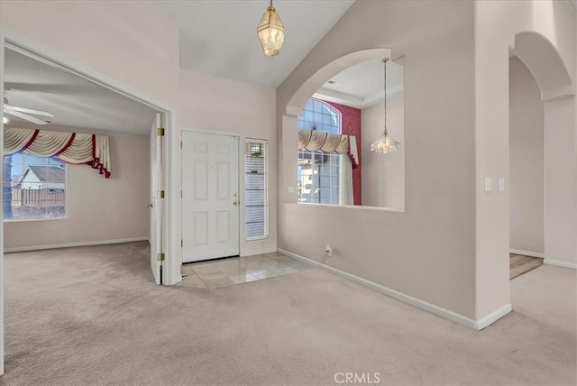 entrance foyer with light carpet and ceiling fan