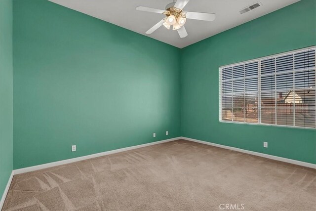 carpeted empty room featuring ceiling fan