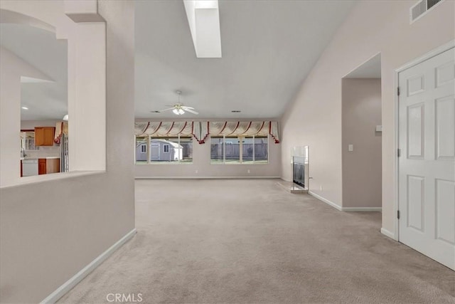 unfurnished living room featuring ceiling fan and light colored carpet