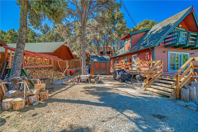 view of yard featuring a storage shed and a wooden deck