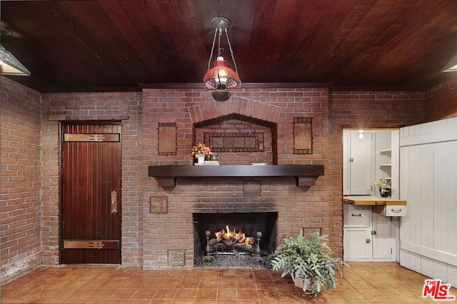 unfurnished living room featuring brick wall, wood ceiling, a fireplace, and wood walls