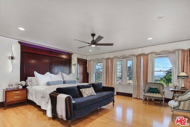 bedroom with ceiling fan and light hardwood / wood-style floors