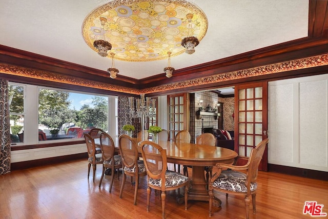 dining room with french doors, hardwood / wood-style flooring, and ornamental molding