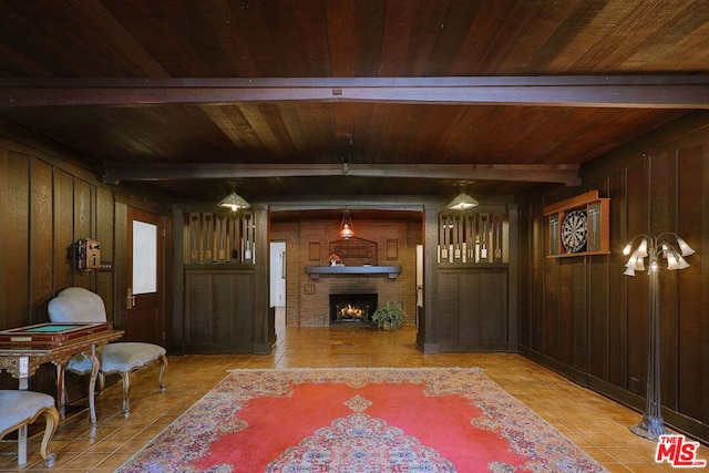 living area featuring wood ceiling, wooden walls, beamed ceiling, and a fireplace