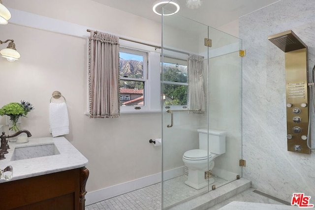 bathroom with vanity, toilet, tile patterned floors, and a shower with door