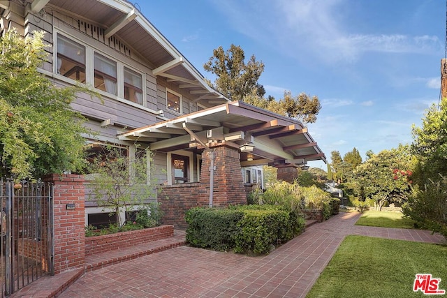 view of side of home with a lawn