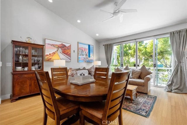 dining space featuring vaulted ceiling, light wood-type flooring, and ceiling fan