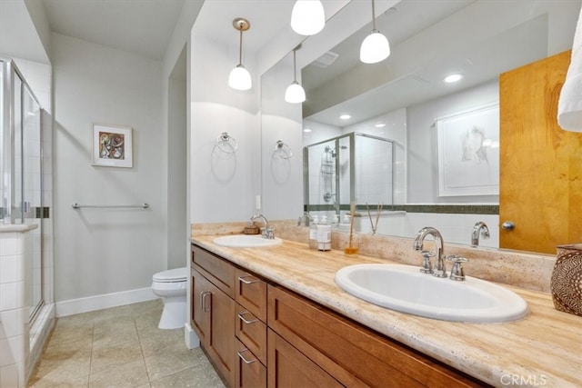 bathroom featuring toilet, an enclosed shower, vanity, and tile patterned flooring