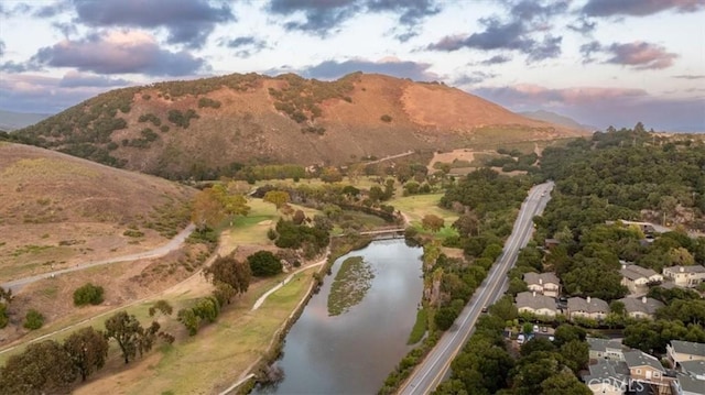 birds eye view of property with a water and mountain view