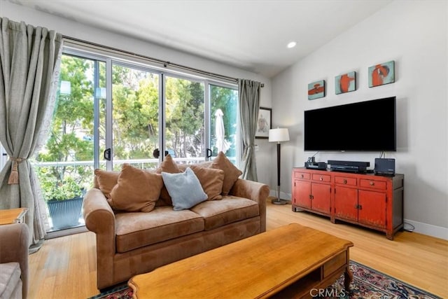 living area with vaulted ceiling, recessed lighting, light wood-type flooring, and baseboards