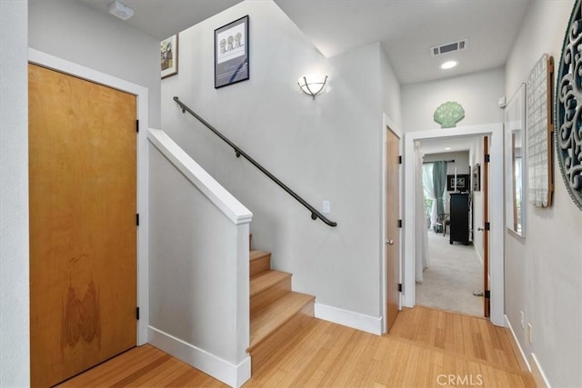 stairway featuring hardwood / wood-style floors