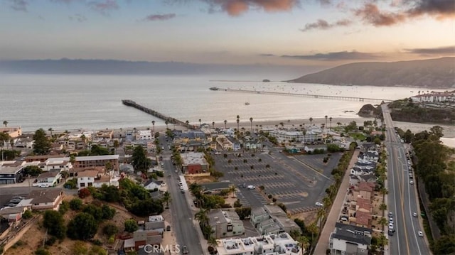 aerial view at dusk with a water view and a city view