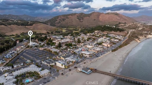 drone / aerial view featuring a water and mountain view