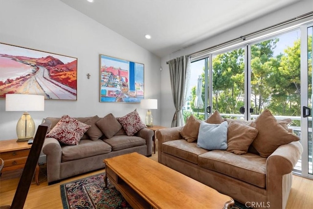 living area with vaulted ceiling, light wood finished floors, and recessed lighting