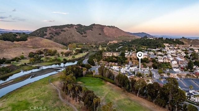 aerial view at dusk with a residential view and a water and mountain view