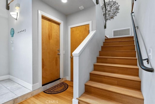 stairs with wood-type flooring