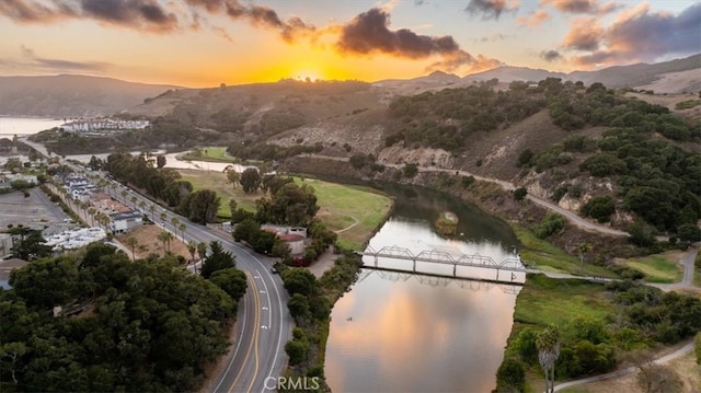 aerial view at dusk with a water and mountain view