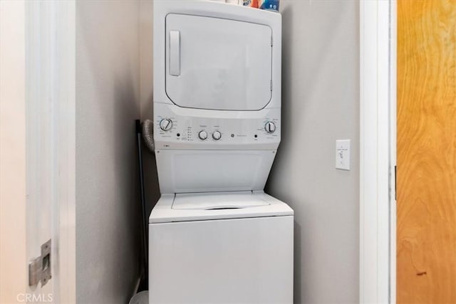 laundry area featuring stacked washer and clothes dryer