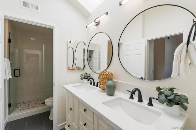 bathroom featuring toilet, tile patterned flooring, an enclosed shower, and vanity