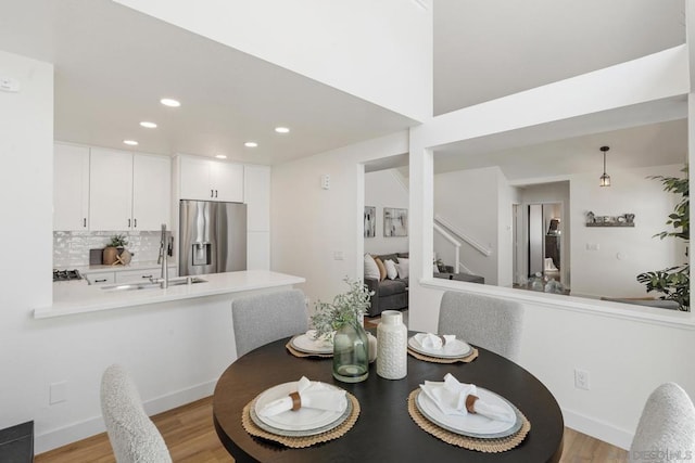 dining space featuring light hardwood / wood-style floors and sink