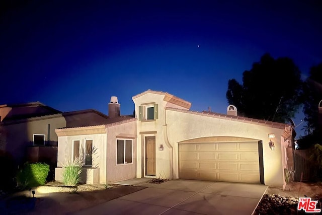 mediterranean / spanish house with a garage