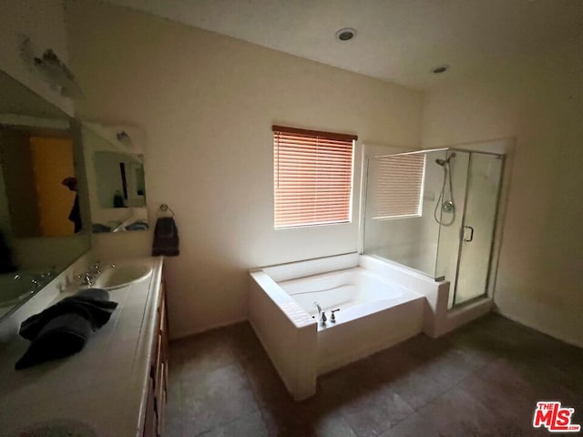 bathroom featuring vanity and plus walk in shower