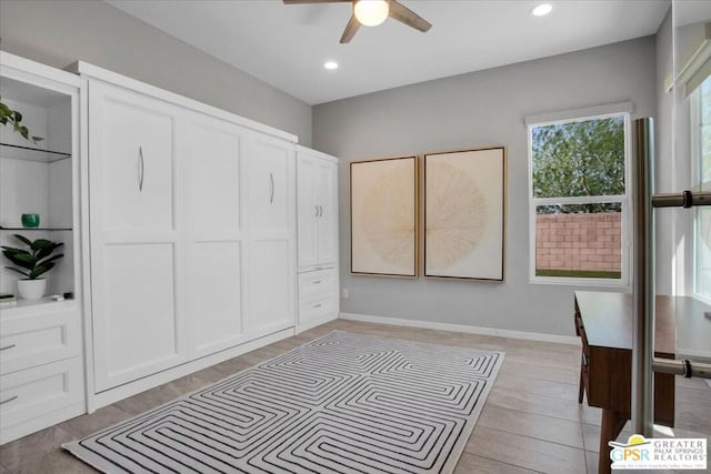 bedroom featuring ceiling fan, light wood-type flooring, and a closet