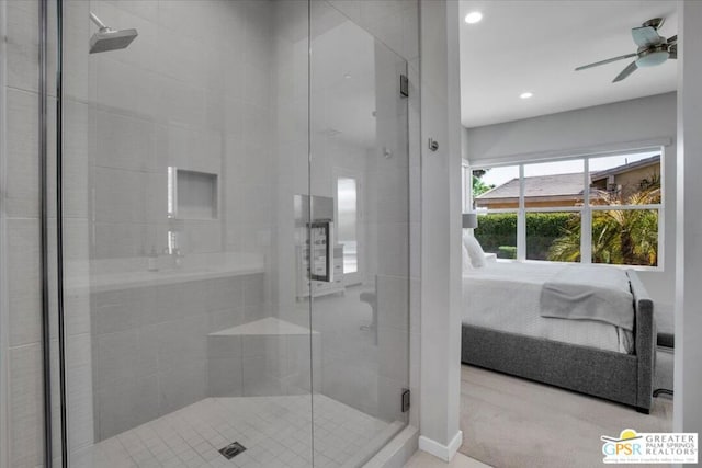 bathroom featuring ceiling fan and a shower with shower door