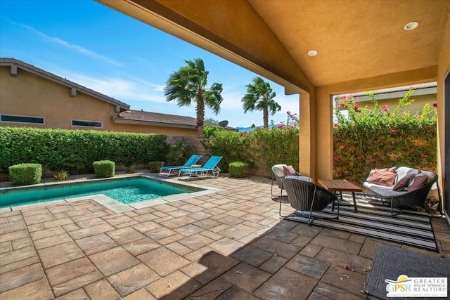 view of swimming pool with a patio area