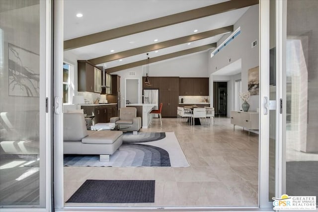 living room featuring vaulted ceiling with beams