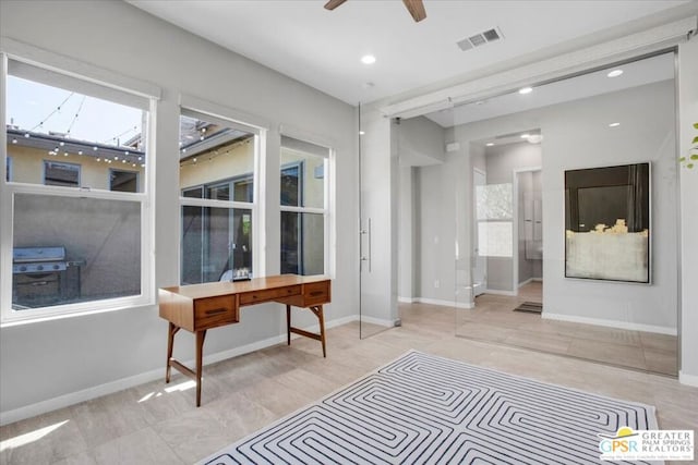 interior space with ceiling fan