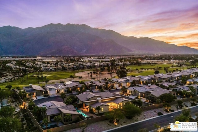 aerial view at dusk featuring a mountain view