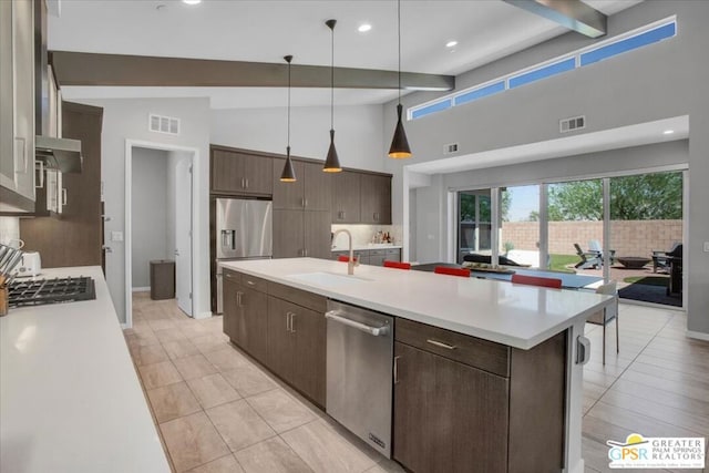 kitchen featuring dark brown cabinets, stainless steel appliances, sink, high vaulted ceiling, and beamed ceiling