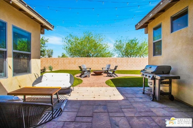 view of patio featuring area for grilling and an outdoor fire pit