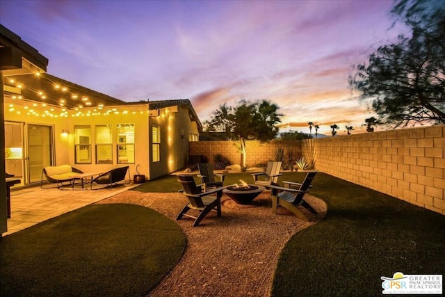 patio terrace at dusk with an outdoor fire pit